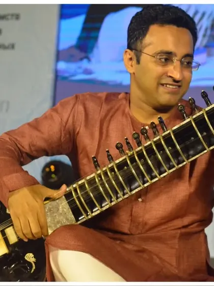 A candid moment of joy while performing a traditional piece at a G20 summit event. I am experienced in setting the right tone for formal and prestigious gatherings.