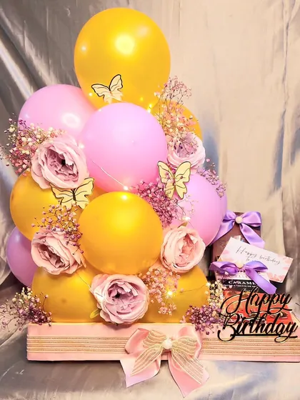 What better way to show love than with balloons and chocolates? This birthday hamper features a cheerful balloon arrangement, a happy birthday sign, and sweet treats.
