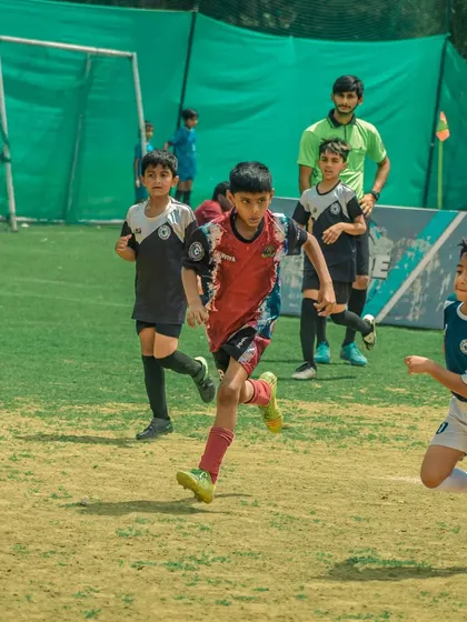Young players chase the ball, showing their enthusiasm and energy for the game.