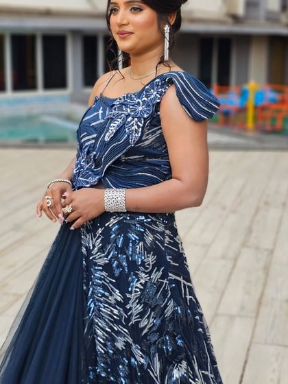 A side view of the client in the blue outfit, showing the intricate silver work.