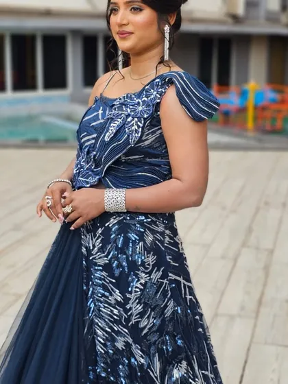 A client looking stunning in a unique navy blue and silver gown. A bold and beautiful choice for a reception.