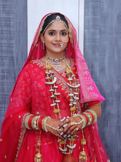 The complete Phera look, including the traditional coconut garland, showcasing a beautiful and authentic bridal style.