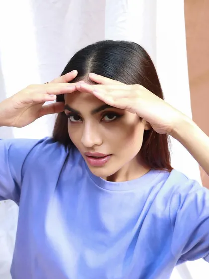 A "no-makeup" makeup look for a casual clothing shoot. The skin is fresh and the hair is styled simply, creating an authentic and relatable image.