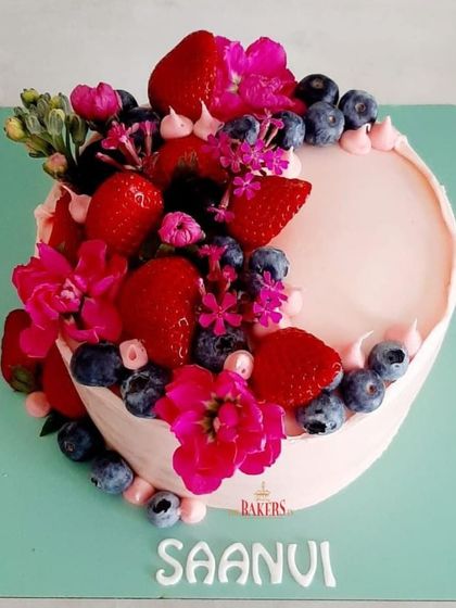 This is one of my favorite designs this season, a beautiful crescent of fresh berries and flowers on a pink cake. It's a simple, no-fondant design that lets the fresh ingredients shine.