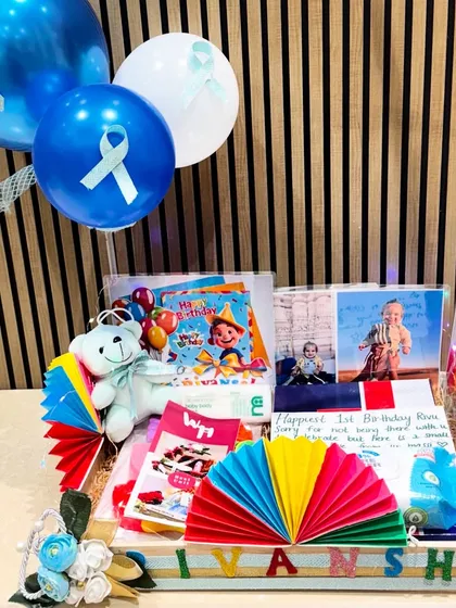 Another angle of the personalized birthday hamper for Rivansh. The balloons and colorful decorations make it a truly festive and exciting gift for a one-year-old.