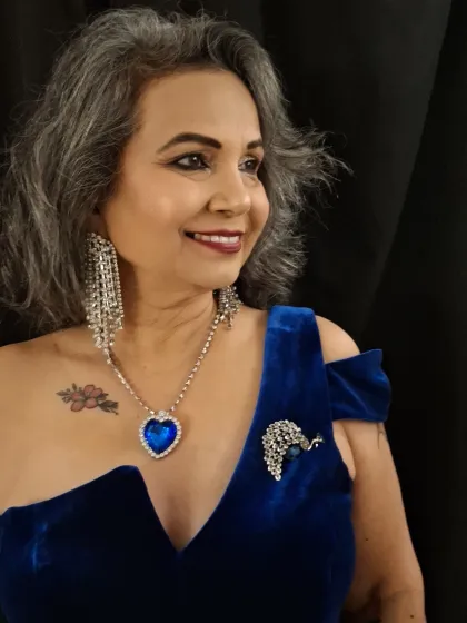 A side profile of the stunning blue and silver glam look. The makeup is designed to be dramatic yet elegant, perfect for a grand evening event.