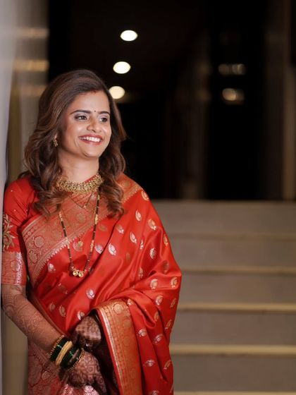 A candid shot of the bride enjoying a moment during her reception, beautifully lit and full of warmth.