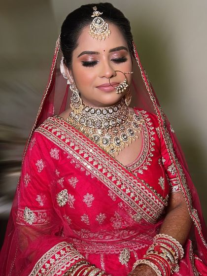 A close-up of Divya's flawless makeup. The skin is glowing, the eyes are defined, and the lip color is the perfect shade to complete the look.