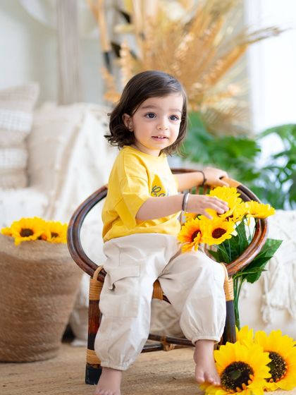 Interacting with the sunflower props. I love capturing these moments of gentle curiosity and play.