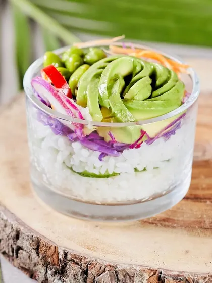 A close-up of our innovative Spicy Avocado Sushi Cup. Layered with sushi rice, wakame, and topped with a creamy yuzu mayo, it's a modern twist on a classic.