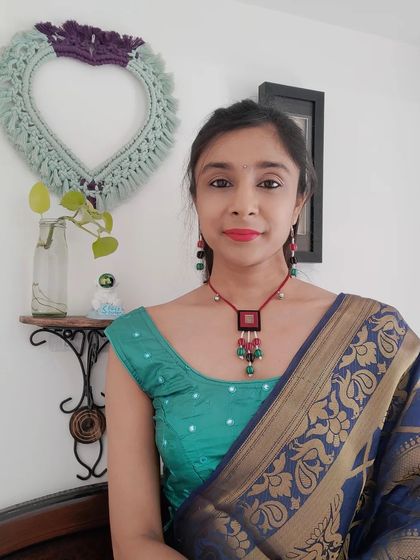 This beaded necklace set with a fabric pendant is perfect for both Navratri and other festive events. The combination of red, green, and black beads with small ghungroos adds a playful touch to any outfit.