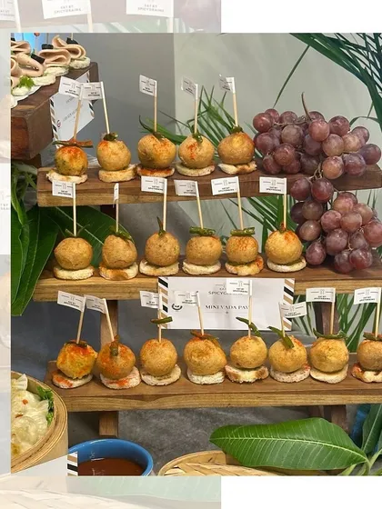 A three-tiered stand filled with our popular Mini Vada Pavs. This presentation allows for easy serving and creates an impressive display for any party.