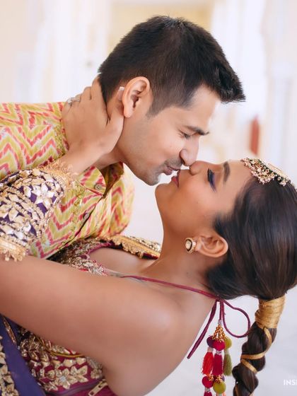 The perfect kiss. This close-up captures an intimate moment and shows off the details of Mishi's makeup, including the colorful eyeliner and glowing skin.