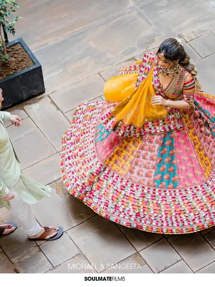 The twirl of a vibrant lehenga against ancient stone. This shot captures the energy, color, and celebration at the heart of an Indian love story. I use dynamic angles like this to bring life and movement to our portraits, making them feel alive.