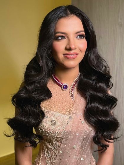 Another portrait of the bride, her glamorous waves and beautiful smile lighting up the room.