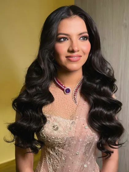 Another portrait of the bride, her glamorous waves and beautiful smile lighting up the room.
