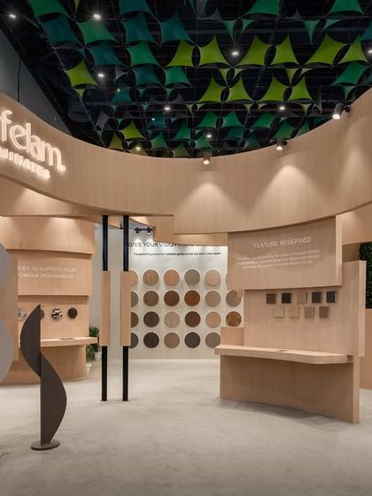Wavy, sculptural forms made from the brand's own laminate product stand at the entrance of the Safelam booth. This creative use of material immediately communicates the product's versatility and the brand's design-forward approach.