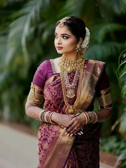 The complete picture of elegance. Shloka's South Indian bridal look is a testament to grace, with every element from her makeup to her hair and jewellery working in perfect harmony.