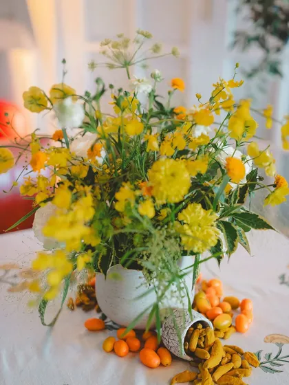 A bright and cheerful floral arrangement of yellow flowers for a Haldi ceremony in the British countryside. We use seasonal, local flowers whenever possible to create fresh and beautiful decor.