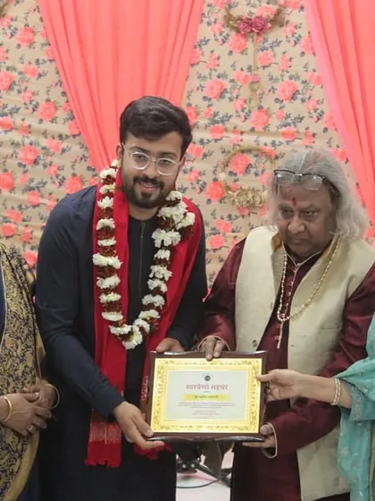 A young artist receiving his award, a proud moment for him and the academy.