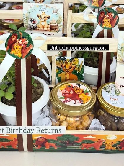 A close-up of the 'Lion King' first birthday return gift, featuring custom stickers of Simba and a personalized thank you card.