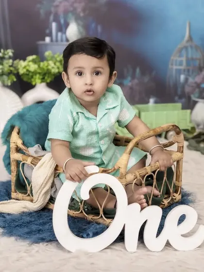 Celebrating one year with a cool blue theme. This little boy is ready for his milestone close-up, sitting in a rustic wicker basket surrounded by a beautifully coordinated set.