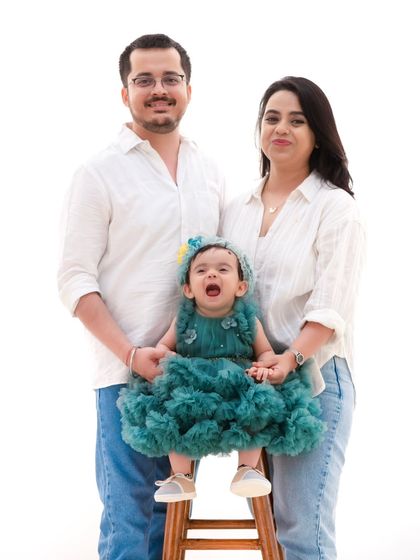 A family portrait that shows off a little personality. The little one's joyful shout brings so much life to this classic family photo.