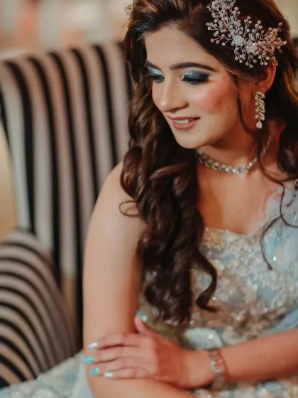 A close-up of the bride's eye makeup. The shimmery blue shadow is blended perfectly for a sophisticated and dramatic effect.