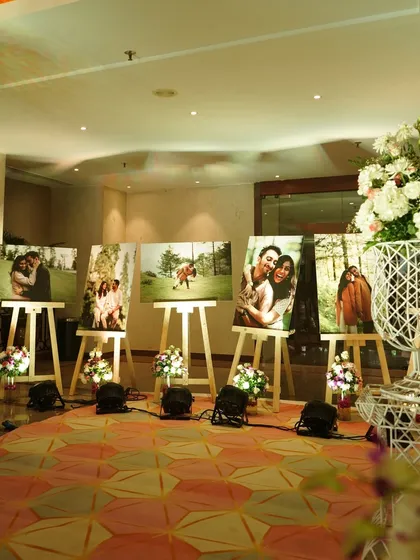 A beautiful way to share your journey with your guests. I set up this gallery of the couple's photos on wooden easels, creating an intimate and personal display.