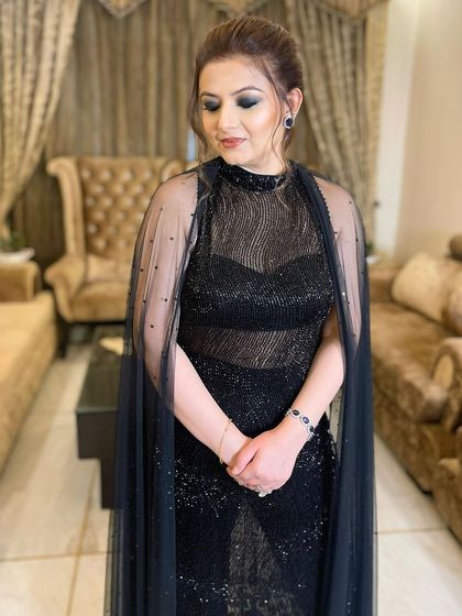 The finished look, with a dramatic black smokey eye and a soft nude lip, creating a balanced and stunning party makeup style.