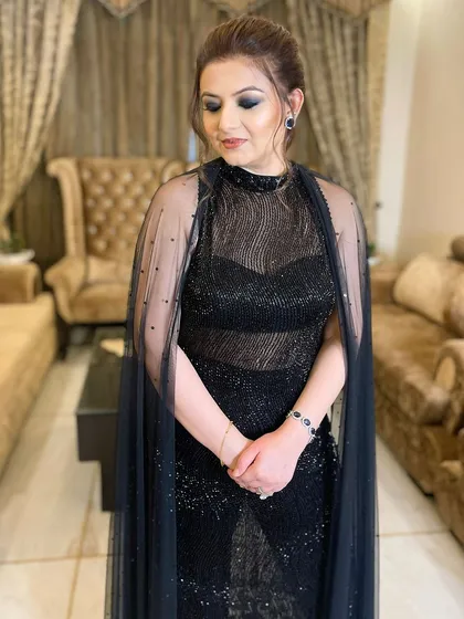 The complete look is the epitome of elegance, with the dark eye makeup providing a stunning focal point.