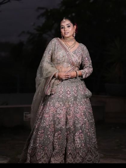 Another full-length pose showing the elegant drape and design of this popular pastel lehenga.