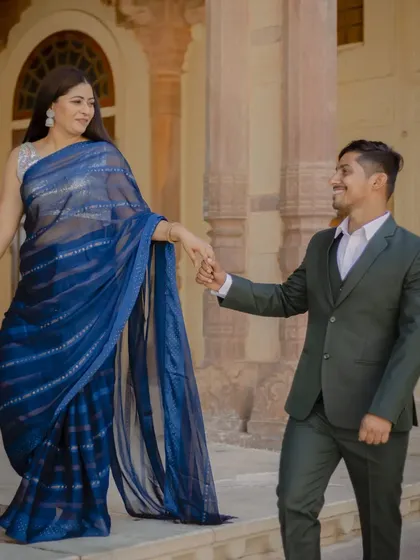 A "follow me" style shot on the steps of the fort. This playful and dynamic pose is great for creating a sense of movement and storytelling in your pre-wedding photos.