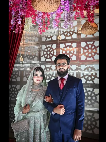 The bride and groom ready to welcome their guests at the reception. This classic portrait captures their poise and happiness as they begin their celebration.