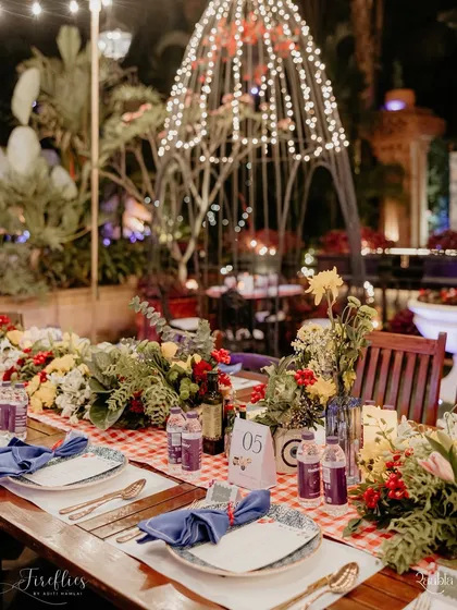 A long, family-style table setting for the Italian gala dinner. The decor was kept rustic and charming, with string lights and birdcage-style installations adding to the warm, communal atmosphere.