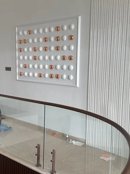 Another shot of the finished relief art, showing its placement in the context of the curved staircase. The piece was designed to be a point of interest as you move between floors, adding a touch of custom elegance.
