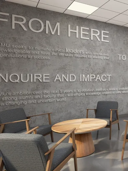 Wall graphics displaying the university's mission statement in the faculty lounge at BML Munjal University. We integrate institutional values directly into the design to reinforce a sense of purpose and community.