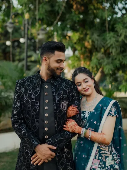 This series of photos captures a stylish couple during their Sangeet. From a romantic forehead kiss to playful poses, these shots showcase their beautiful coordinated outfits and happy connection.
