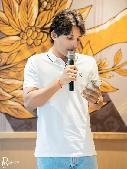 A poet reads from his phone, contributing his voice to the theme. The event took place at the picturesque Tim Hortons in Bangalore.