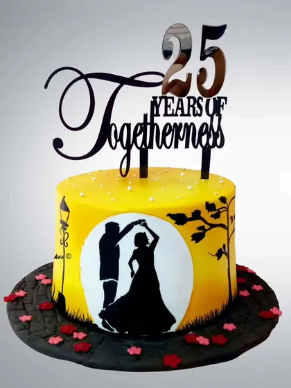 A silhouette cake celebrating 25 years of togetherness. The romantic dancing couple against a golden moon creates a beautiful and timeless design for a silver anniversary.