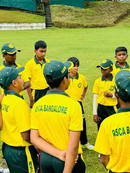 A coach giving a team talk to the U-16 squad during their international tour. These sessions are vital for strategy and motivation.