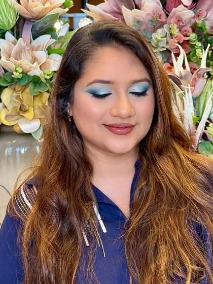 With eyes closed, you can see the full artistry of this blended teal eyeshadow. This shot showcases the smooth gradient of color, a key technique I teach for creating professional-looking eye makeup.