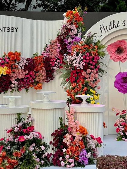 A close-up of the cascading floral arrangements on the display pedestals. I use a variety of flowers and colors to create texture and depth, making the decor feel lush and luxurious.