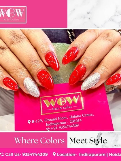 A vibrant combination of bold red and sparkling silver glitter on long, almond-shaped extensions. This look proves that you can have both dramatic color and dazzling shine.