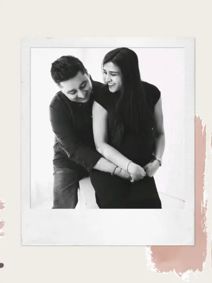 Laughter and love captured in a timeless black and white polaroid-style photo. This candid moment shows the genuine happiness of the expecting couple.
