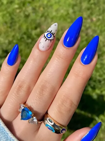 The full evil eye manicure, showing how the bold blue and detailed accent nail create a powerful and stylish statement.