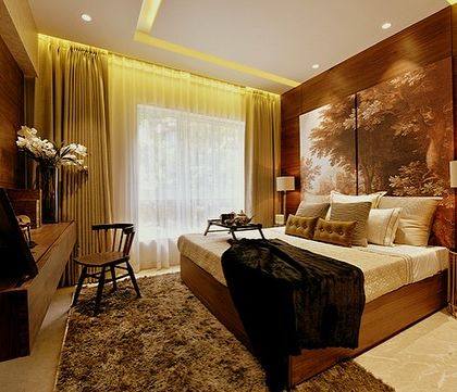 Another view of the tropical-themed bedroom at our Bellevue project. The warm lighting and rich wooden textures create a cozy, den-like atmosphere that is perfect for relaxation.