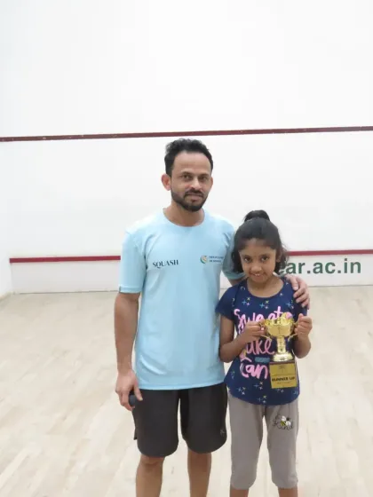 The best part of my job is seeing a player's joy after a hard-earned victory. Here I am with Tulasi, celebrating her runner-up finish at a state-level tournament.