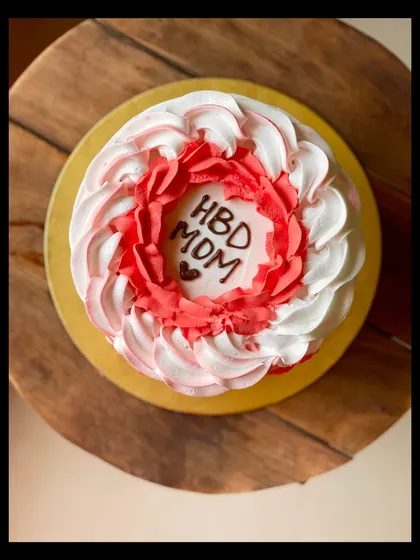 A top-down view of the pretty red and white swirled cake for a mom's birthday.
