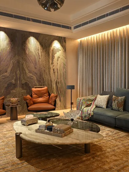 Here, accent lighting is used to draw attention to the stunning marble wall. This technique adds texture and drama to the living space, all controlled with a simple tap.